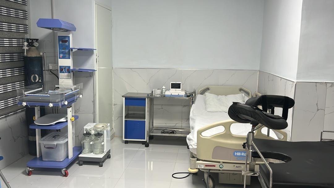 a brown French bulldog puppy laying down and looking up with a hopeful look in its eyes. 
